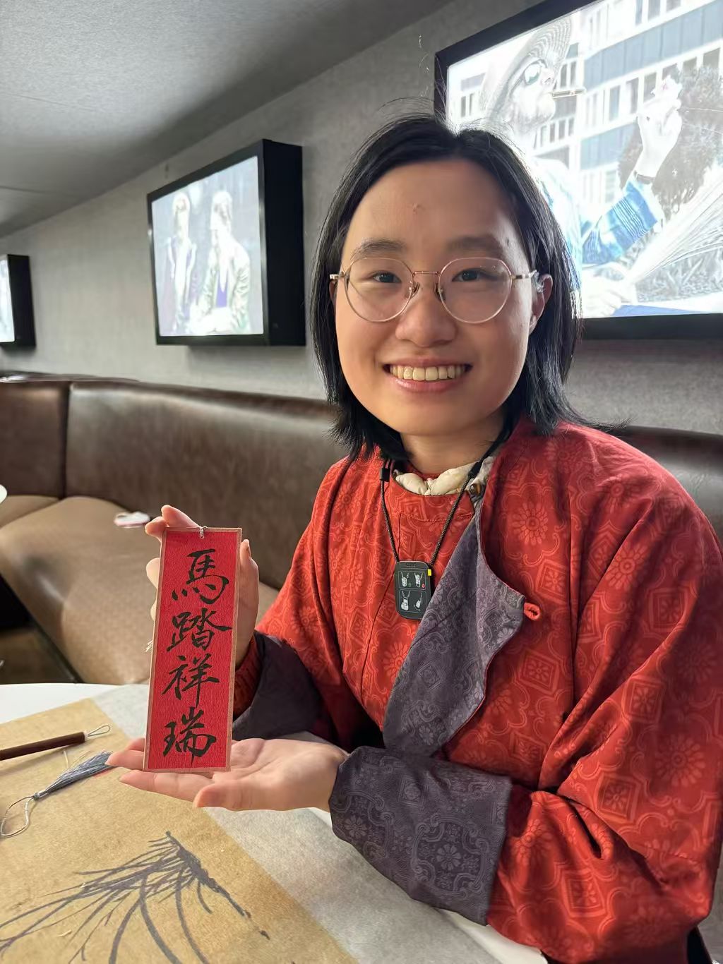 Ruiting Zou holding her calligraphy bookmark